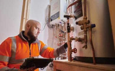 A person looking at a water heater.
