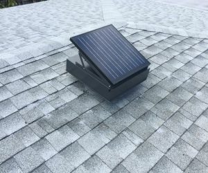 Remington Solar attic fan on a gray, shingled roof.