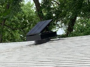 A Remington Solar attic fan on the roof of a building – Remington Solar