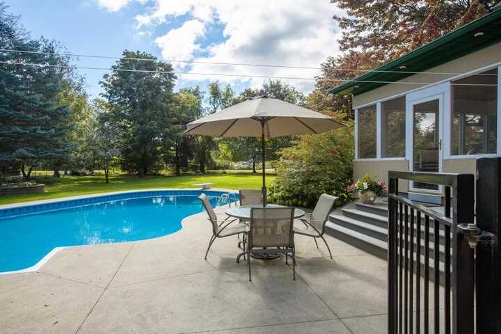 A patio with an inground swimming pool.