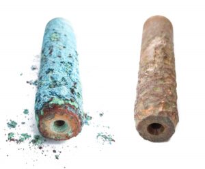 An old copper anode next to one that has been cleaned with SOak and Rinse.